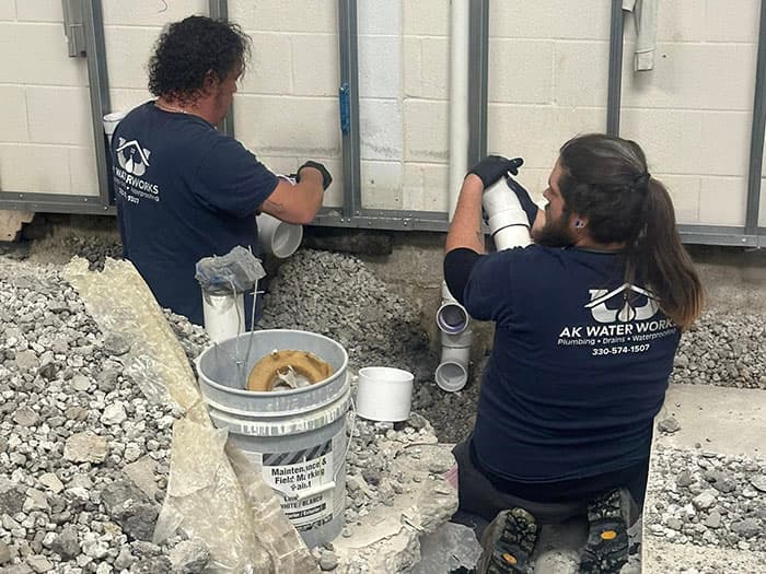 AK Water Works plumbers repairing pipes on a job site