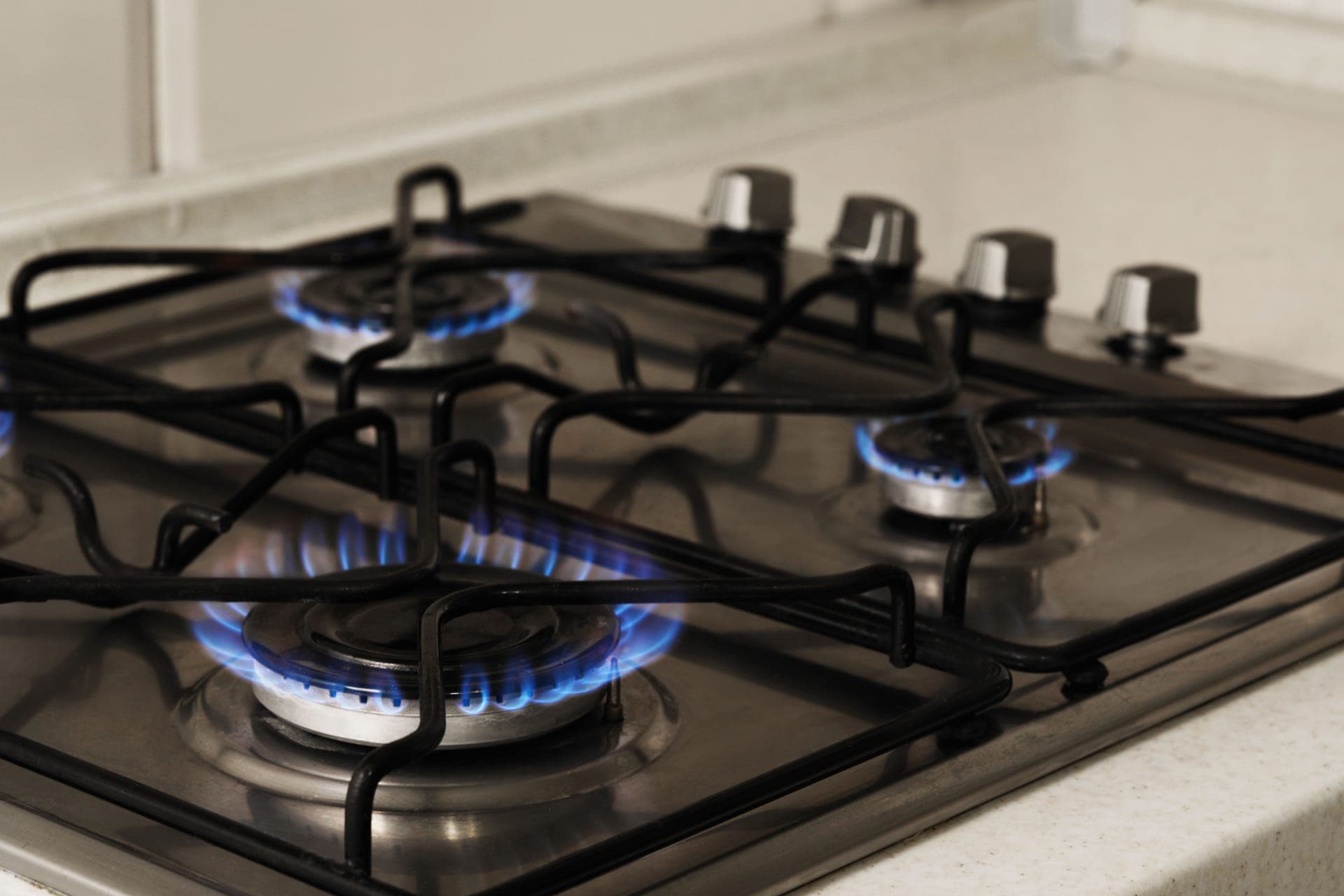Blue flame on a gas stove burner after a licensed plumber connected the range