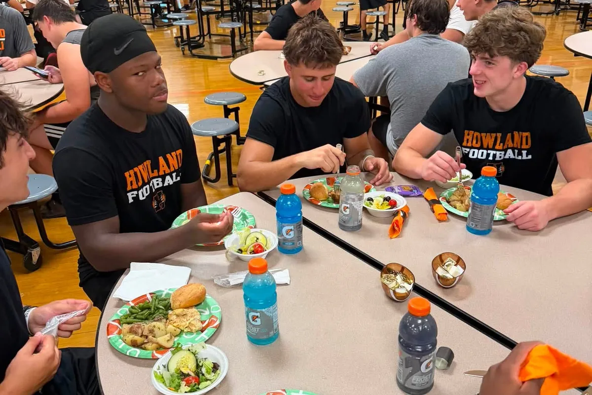 Howland Tigers football players eating a Mocha House lunch in the school cafeteria